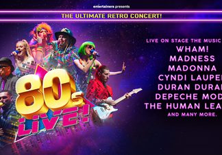 Singers dressed as 80s icons; Cyndi Lauper, Boy George alongside a guitarist and backing vocalists.