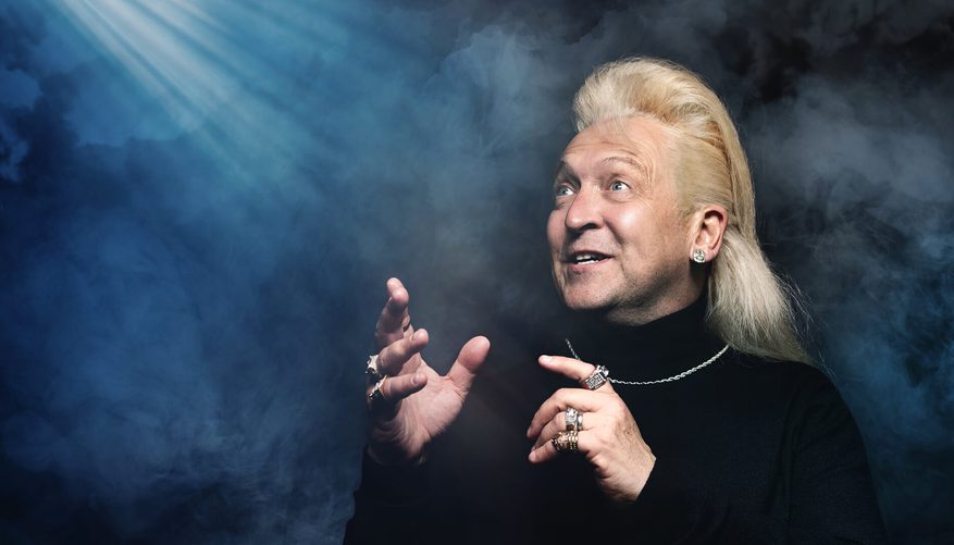 Light beams shining down on Clinton Baptiste.