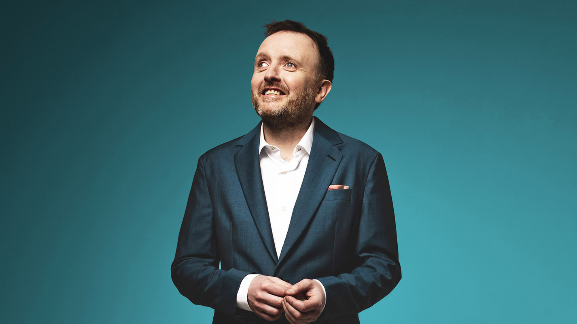 Chris McCausland looking to the left of the frame.