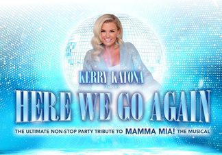 Kerry Katona stood in front of a silver glitterball.