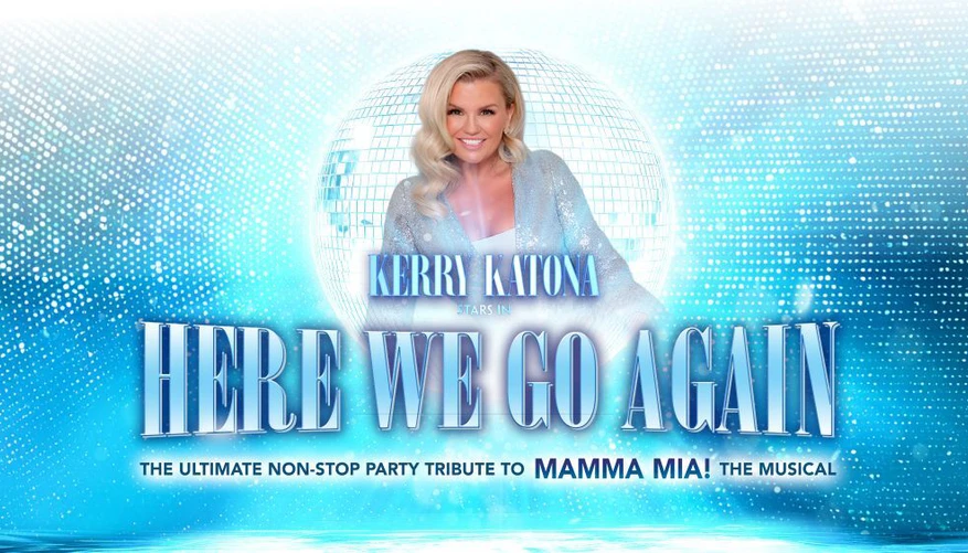 Kerry Katona stood in front of a silver glitterball.