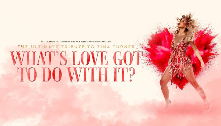 Woman wearing a red dress and heals in front of a red paint explosion in the shape of a heart.