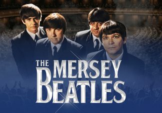 Four men in black suits with the inside of a venue behind.