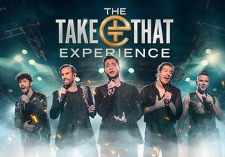 All five band members singing with smoke and bright lights.