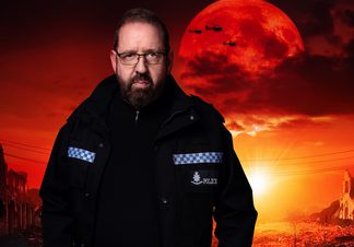 Man in police uniform looking towards camera with dystopian scene behind him.