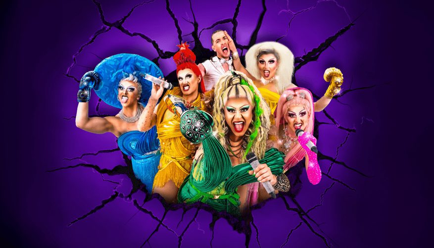 Five drag queens posing with one man in the background.